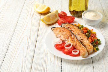 Composition with tasty grilled salmon on wooden background, space for text