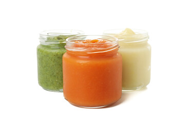 Glass jars with healthy baby food isolated on white background