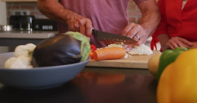 Senior Caucasian couple cooking together in the kitchen