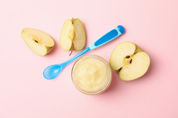 Fototapeta na wymiar Vegetable puree, apples and spoon on pink background. Baby food