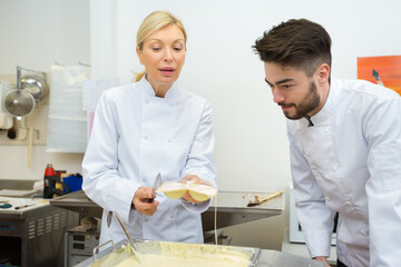 portrait of two workers making chocolate