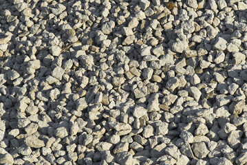 large crushed stone texture. Small pebble stones on construction site. gravel pebble stones background.