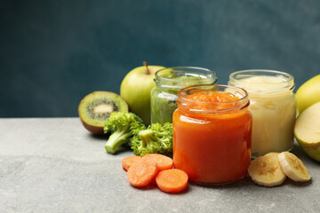 Composition with baby food on gray background, close up