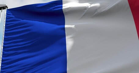 Bastille Day is the national day of France. France flag on flagpole waving in wind.