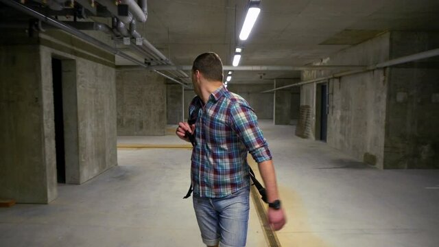 Man walking through a basement looking around