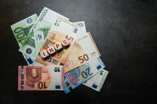 euro banknotes  with INPS Italian pension institution inscription on a dark surface view from top whit copy space