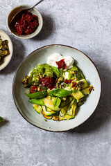 Vegetarian dish with courgette, pesto and pumpkin seeds