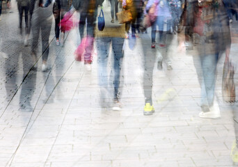 Abstract crowd of walking people while shopping in the pedestrian zone, multiple exposure, copy space - obrazy, fototapety, plakaty