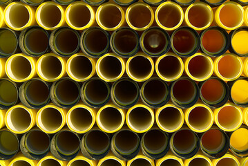 yellow plastic pipes for laying electricity cables underground. texture or abstract background.