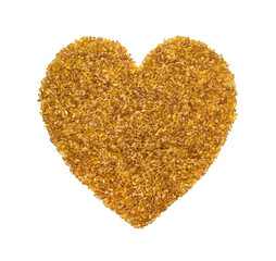bulgur grains in the form of a heart on a white background as a symbol of healthy nutrition for vegans and vegetarians