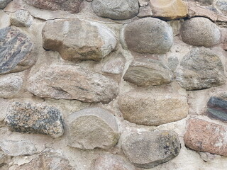 High fence of large boulders of stones reliably protects the estate