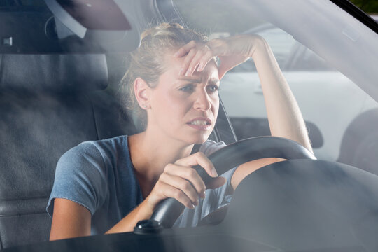 bored woman sitting in a car in traffic jam