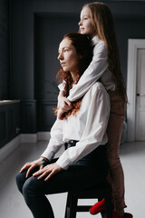 Two sisters embrace in the loft, representing friendship, trust, similarity