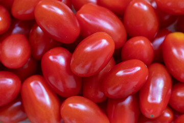 Red round cherry tomatoes for background or wallpaper. Natural product