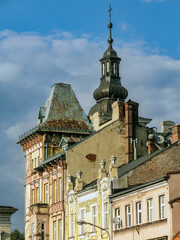 Rooftops of old houses and a church tower against the blue sky, Bielsko-Biała, Poland