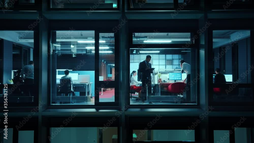 Aufkleber footage from outside the window: businessmen and businesswomen working in the office. managers and s