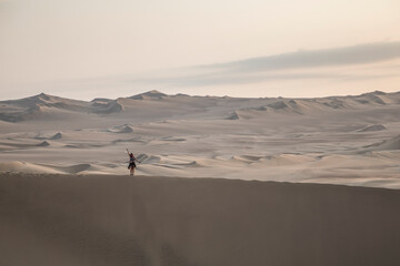 Fototapeta na wymiar woman on a top of a dune
