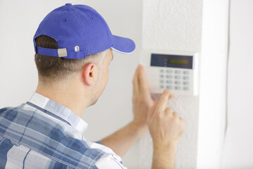 a technician testing a thermostat