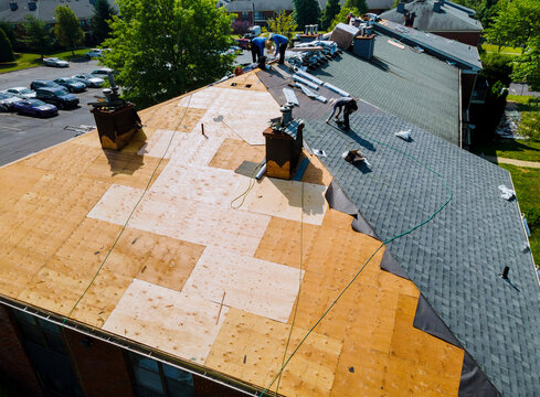 Roof repairs old roof replacement with new shingles of an apartment