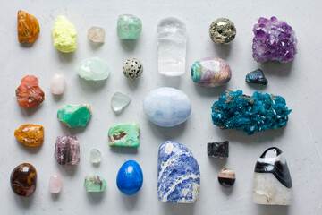 Beautiful bright multi-colored collection of natural stones and minerals from around world lies on...
