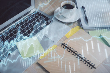 Multi exposure of forex graph drawing and desktop with coffee and items on table background. Concept of financial market trading