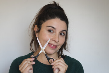 young woman with hairstyling scissors