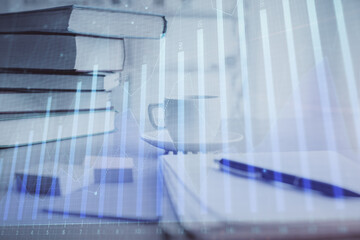 Double exposure of financial chart drawing and desktop with coffee and items on table background. Concept of forex market trading