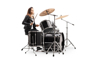 Fototapeta na wymiar Young female musician playing a drum kit