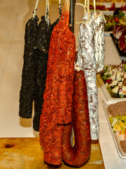 Traditional dried Catalonian sausages exposed for customers during dinner.