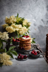  Breakfast Pancakes with  Cherries, Homemade American pancakes served withfresh cherry on a wooden background, sweet dessert 