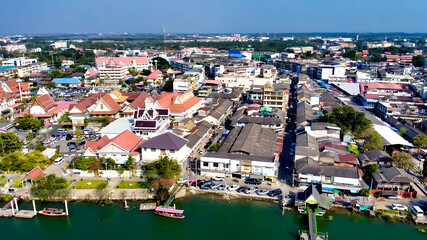 Naklejka na ściany i meble Aerial view of Maeklong railway market and city skyline, Thailand