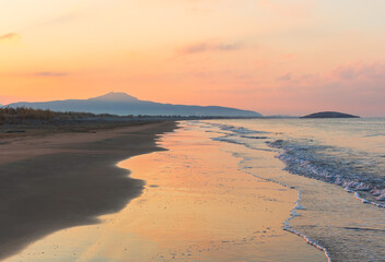 Fantastic Mediterranean seascape in Turkey. Amazing sunrise on Patara beach, Mugla Province. 
Morning orange clouds reflected in calm water.