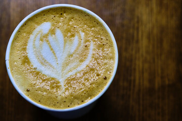 close up modern hot black coffee the cappuccino on dark background with coffee bubble foam pattern and texture in black cup looking and feel so delicious on glasses table in coffee shop.