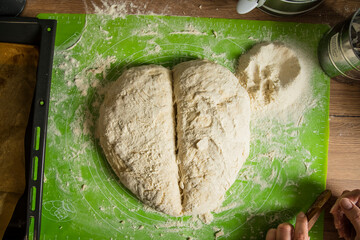 Homemade dough in the shape of a heart on a kitchen counter