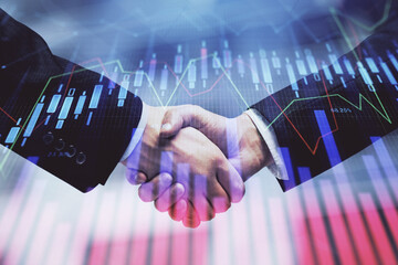 Double exposure of forex graph hologram and handshake of two men. Stock market concept.