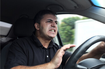 Angry man driver honking while driving car without seat belts