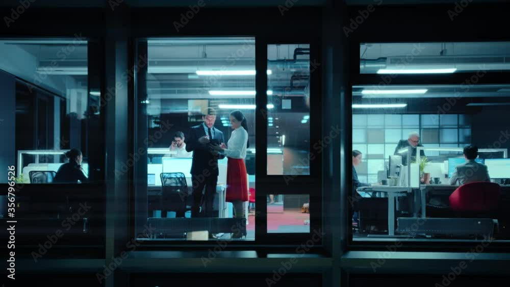 Poster footage from outside: two business partners meet and use a tablet in office. managers standing by th