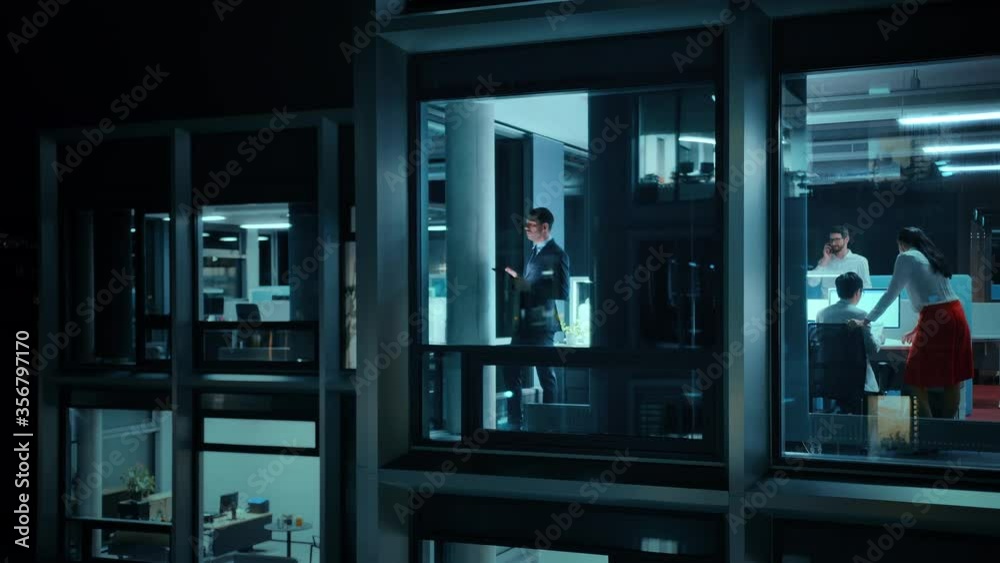 Poster Footage from Outside: Businessman Working on a Digital Tablet Computer in the Office. Manager Checking Emails while Standing by the Window. Employee Planning Financial Tasks and Business Development.