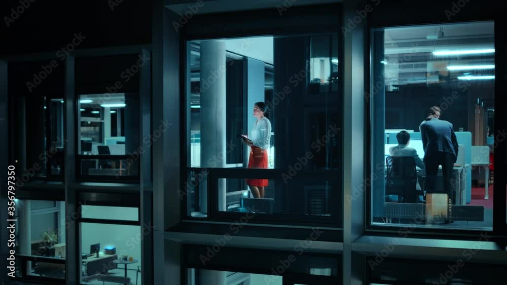 Poster Footage from Outside: Businesswoman Working on a Tablet Computer in the Office. Manager Checking Emails while Standing by the Window. Employee Planning Financial Tasks and Business Development.