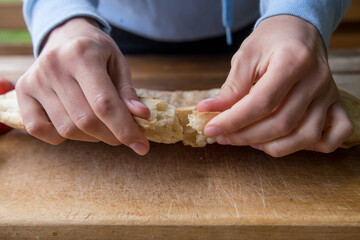 girl breaks pita bread with her hands on a picnic at the campsite