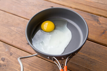 fried scrambled eggs in a pan on a picnic at the campsite