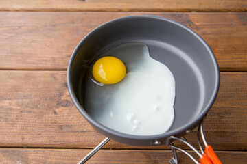 fried scrambled eggs in a pan on a picnic at the campsite