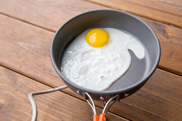 fried scrambled eggs in a pan on a picnic at the campsite