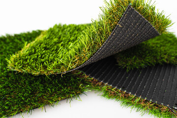 Sample pieces of green artificial grass of different thickness.