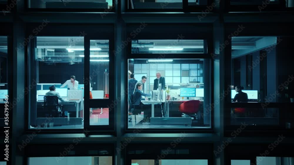 Poster footage from outside the window: businessmen and businesswomen working in the office. managers and s