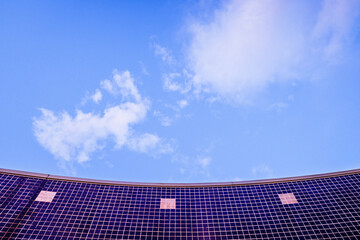 blue tile wall with clear blue day sky background.