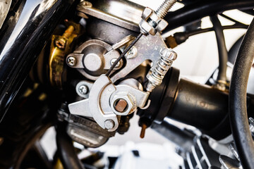 Detail of the gasoline engine and carburetor of a motorcycle.
