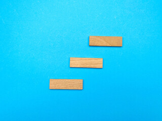 Successful idea concept, wooden stairs up on blue background