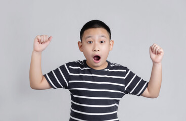 Boy wearing casual t-shirt standing over background afraid and shocked with surprise expression, fear and excited face.