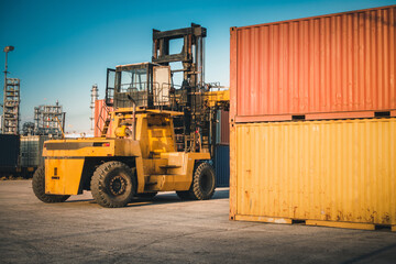 Container Ship Loading of Import/Export Freight Transportation Industry, Transport Crane Forklift is Lifting Box Containers at Port Cargo Shipping Dock Yard. Logistic Freighting Ship Service